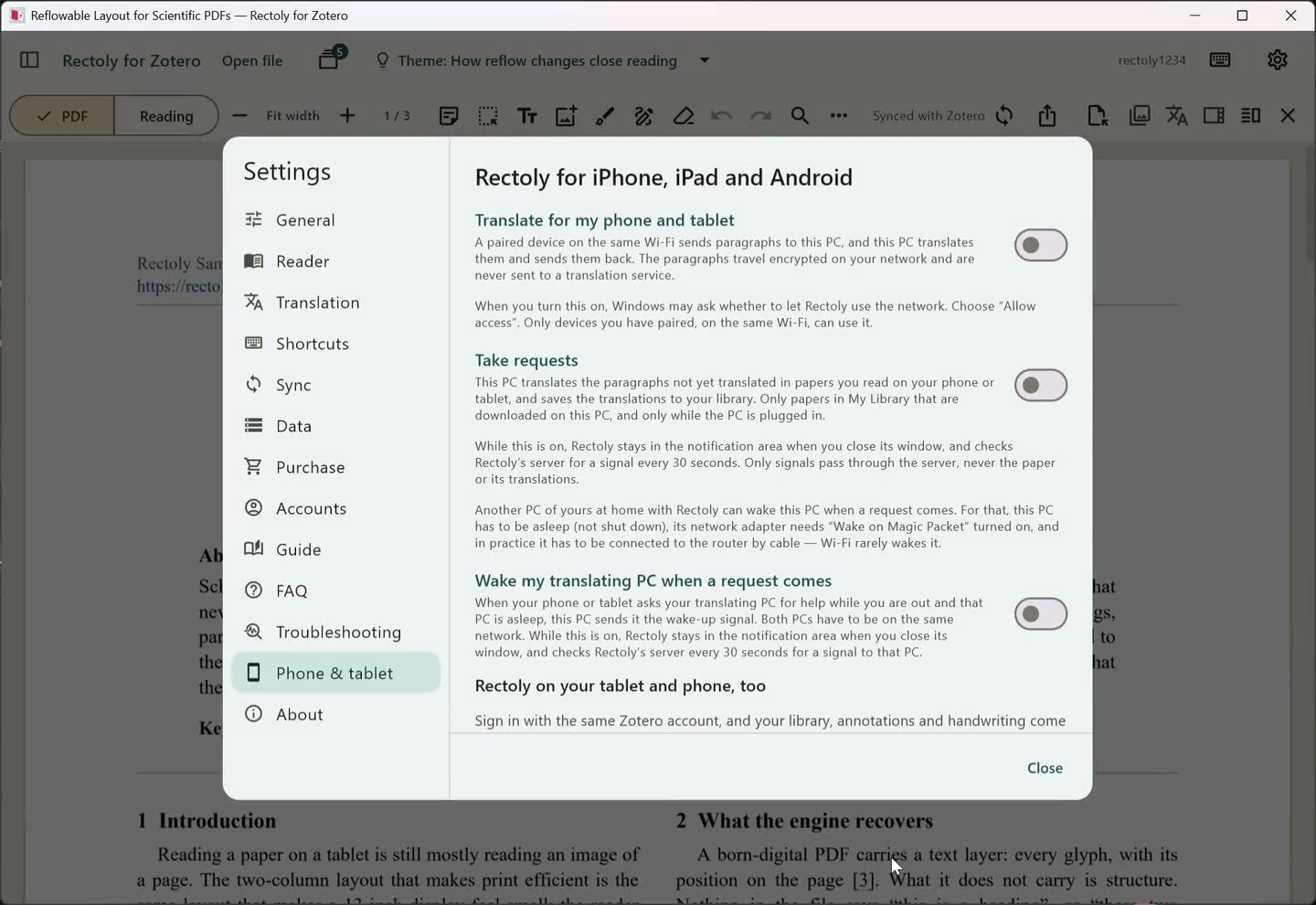 A tablet paired with the computer, which is translating a paper on its behalf